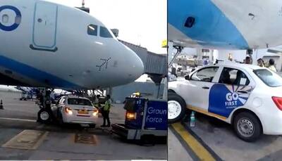 SHOCKING! Go First car goes under IndiGo plane at Delhi Airport, narrowly escapes collision - WATCH Video