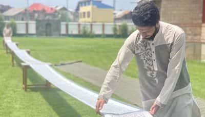 Kashmiri youth creates world record, writes Holy Quran on 500 metres scroll