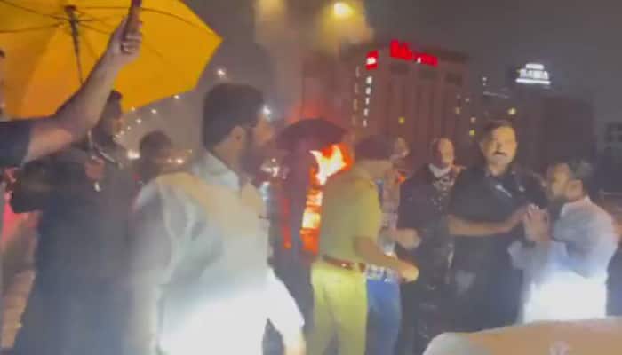 Car catches fire in Mumbai; Eknath Shinde, whose convoy was passing by, stops to help - WATCH