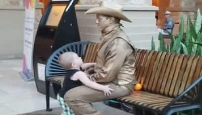 Little kid hugs man acting as statue, here's what happened next- Watch