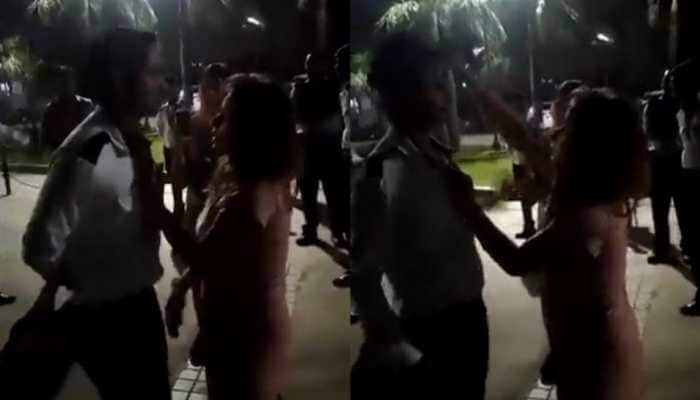 Noida: Drunk woman grabs society guard by collar, flings his cap in the air - WATCH