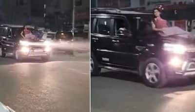 WATCH: Woman in Noida performs dangerous stunt on Mahindra Scorpio SUV, Police takes strict action