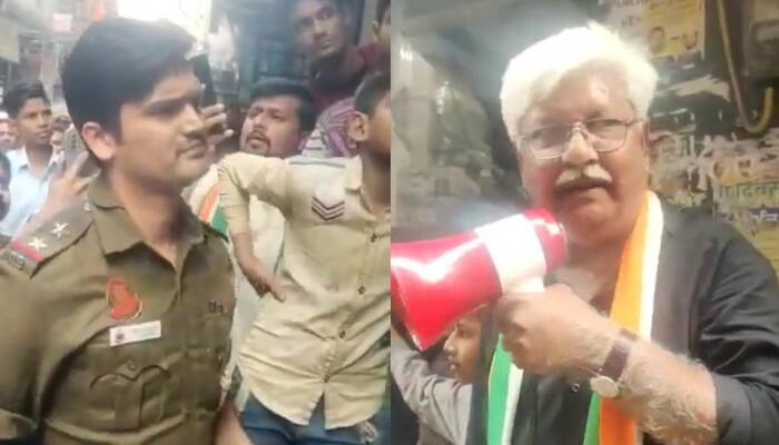 WATCH: Congress MCD candidate&#039;s father MANHANDLES cop in Shaheen Bagh; FIR registered