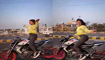 Viral video: Girl dances to trending Bhojpuri song 'Patli Kamariya' while riding bike, netizens upset- WATCH