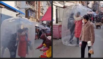 Covid bubble: Couple in China uses innovative 'shield' in public against Covid- watch video viral