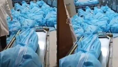 Covid outbreak in China: Dead bodies wrapped in blue plastic pile up on hospital floor - Watch shocking video