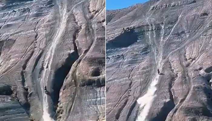 SCARY! Man rides bike on near vertical mountain, skids on the way up: Watch VIRAL video