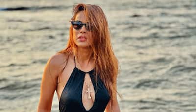 Nia Sharma burns internet, flaunts her dance moves in black cut-out swimsuit on beach 	
