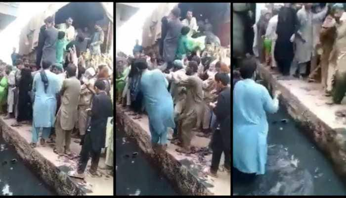 Pakistan food crisis: Man pushes another into open sewage during Atta distribution - WATCH