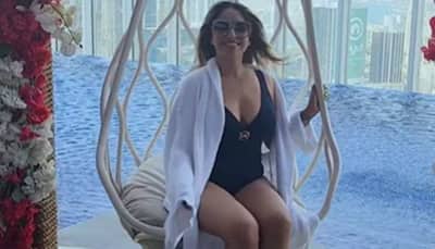 Neha Bhasin sizzles near the pool in a black swimsuit and white bathrobe, enjoys windy, cold Dubai - Watch viral video