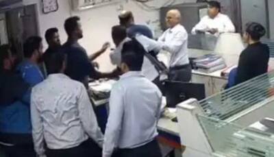 Bank of India Employee Thrashed by Customers Over Loan Issue-- Watch