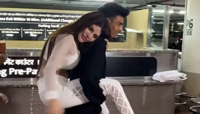 Sherlyn Chopra Shocks Paps, Gets Piggyback Ride On A Guy At Airport - Watch