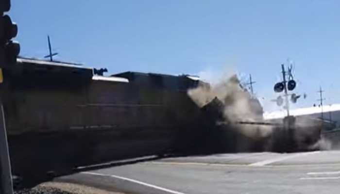 Watch: Truck Carrying Tractor Gets Tossed In Air After Collision With Train