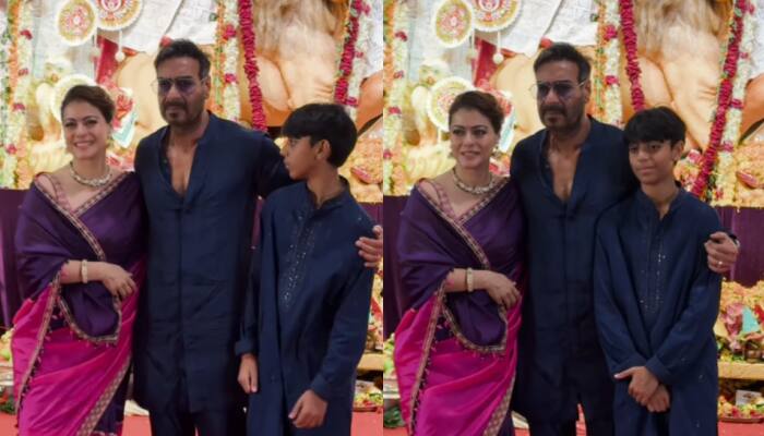 Kajol Pinches Ajay Devgn To Keep His Hand On Her Shoulder As They Pose At Durga Panday Along With Son Yug Devgn