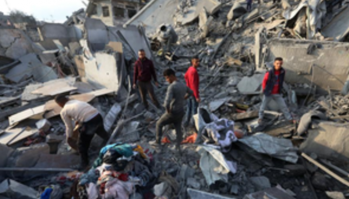 Palestinian Man Searches For Family Beneath Rubble After Israeli Strike Claims Dozens In Gaza Palestinian Man Searches For Family Beneath Rubble After Israeli Strike Claims Dozens In Gaza